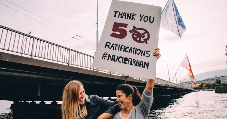 Duas mulheres segurando cartaz de agradecimento