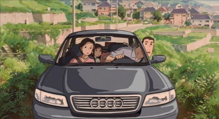 Chihiro e seus pais no carro vendo que o caminho está bloqueado